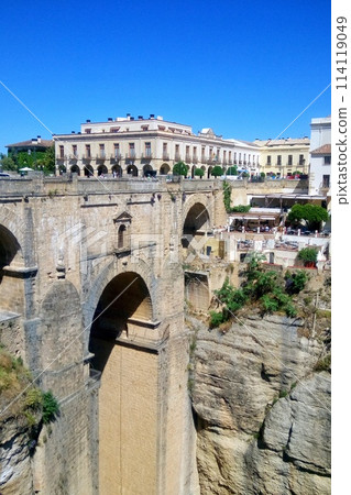 Puente Nuevo arch bridge over the Tajo gorge at Ronda village, Spain. Tourist viewpoint cliff in Ronda province of Malaga, Andalucia Puente Nuevo arch bridge over the Tajo gorge at Ronda village, Spain. Tourist viewpoint cliff in Ronda province of Malaga, Andalucia 114119049