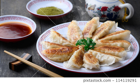 Fried dumplings (black background) with sauce and matcha salt Fried dumplings (black background) with sauce and matcha salt 114119291
