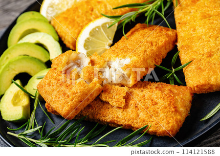 crispy baked battered pollock fillet on a plate 114121588