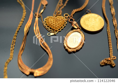 Many gold necklaces on a black background Many gold necklaces on a black background 114122046