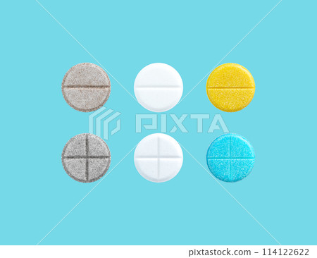 Different colored pills in a row on blue background with copy space. Biologically active additives. Medical concept. Different colored pills in a row on blue background with copy space. Biologically active additives. Medical concept. 114122622