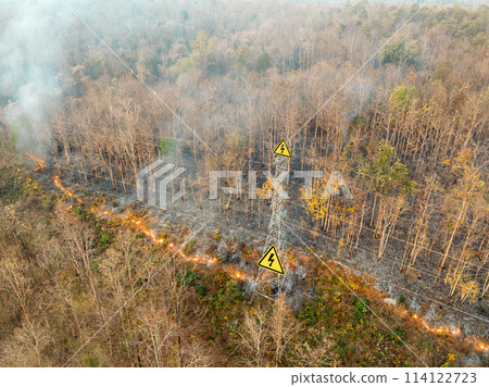 Bushfire is burning near power transmission tower line. Bushfire is burning near power transmission tower line. 114122723