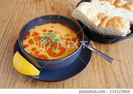 Lentil or tripe soup on wooden textured table 114123668