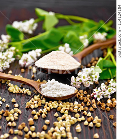 Flour buckwheat green and brown in spoons on table Flour buckwheat green and brown in spoons on table 114124184