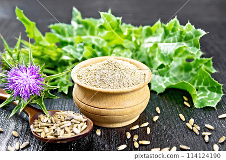 Flour milk thistle in bowl on board Flour milk thistle in bowl on board 114124190