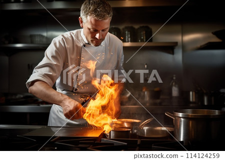 A chef in a white work uniform and a chef's hat prepares a dish in a frying pan with fire. 114124259