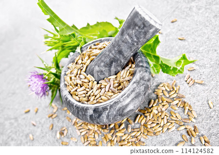 Seeds milk thistle in mortar on granite table 114124582