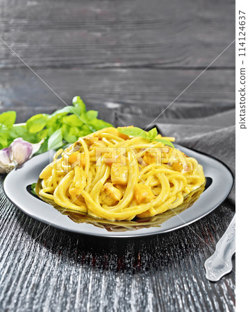 Spaghetti with pumpkin and bacon in plate on wooden table 114124637