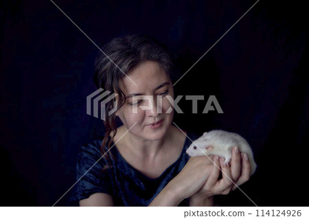 a husky dumbo rat cuddles with its owner a husky dumbo rat cuddles with its owner 114124926