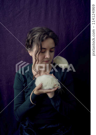 an  albino  standard rat and albino standard rat cuddles with theie owner 114124969