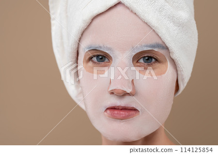 Beautiful woman with cosmetic mask on face Beautiful woman with cosmetic mask on face 114125854
