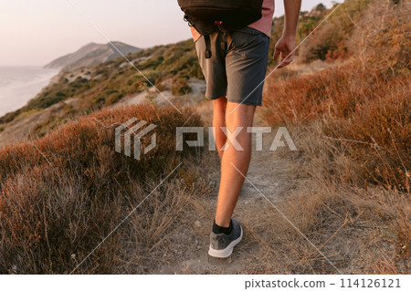 Legs of man walk outdoor with evening sunlight. Legs of man walk outdoor with evening sunlight. 114126121