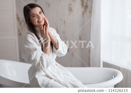 Beautiful young brunette woman posing in a bathrobe 114126215