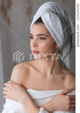 Spa Woman. Attractive woman feeling her skin smooth and well-groomed after bath. 114126309