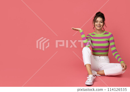 A young girl poses on a plain background 114126535