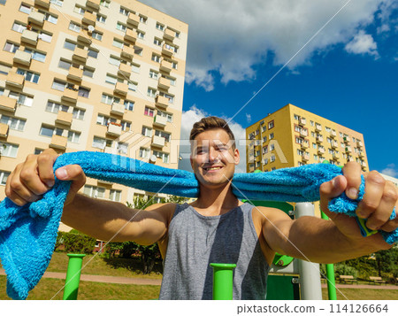 Young man relaxing after outdoor workout 114126664