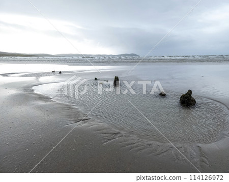 The remains of the unknown shipwreck become visible during the storm at Dooey beach by Lettermacaward in County Donegal - Ireland The remains of the unknown shipwreck become visible during the storm at Dooey beach by Lettermacaward in County Donegal - Ireland 114126972