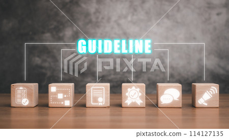 Guideline concept, Wooden block on desk with guideline icon on virtual screen. 114127135