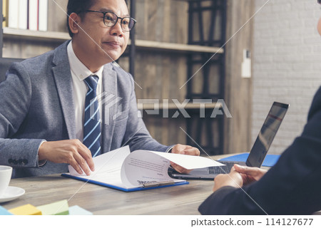 Job HR applicants having an interview with Human resource manager jobs interviewing with confident candidate at business firm office give cv resume. Job Interview with headhunter agent and applicant 114127677