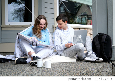 nice to do homework together with a friend boys girl sitting on the porch laptop briefcase folder outside home sneakers sportswear pleasant relationship First love Classmates teenagers adolescence nice to do homework together with a friend boys girl sitting on the porch laptop briefcase folder outside home sneakers sportswear pleasant relationship First love Classmates teenagers adolescence 114127803
