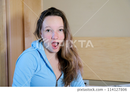 Close up, Woman surprise showing product . Presenting your product. Expressive facial expressions. Close up, Woman surprise showing product . Presenting your product. Expressive facial expressions. 114127806