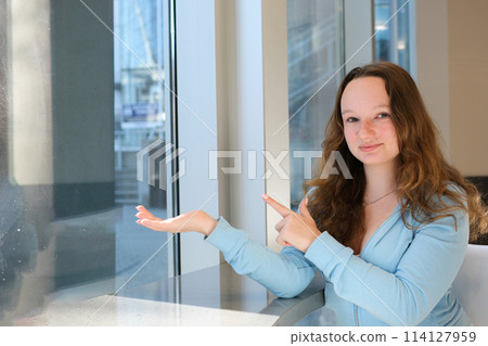 Relaxed girl looking at cell phone with cup of coffee, Shopping in an online store Relaxed girl looking at cell phone with cup of coffee, Shopping in an online store 114127959