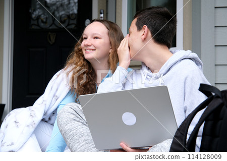 Couple of teenagers, saying things in your ear  114128009
