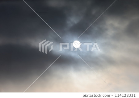 Cloudy skies and the sun 114128331