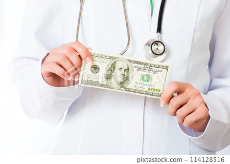 Doctor's hands with banknote 114128516