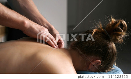 Massage Therapist Doing Shoulders Massage In Spa 114128523