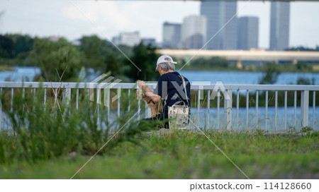 Senior man standing on the riverbank 114128660