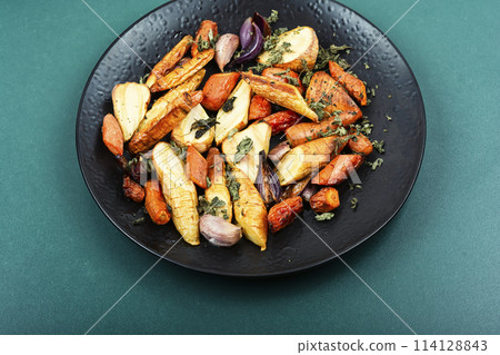 Roasted parsnip root and carrots. 114128843