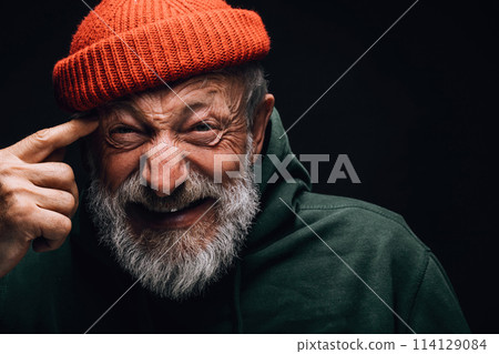 Old man, looking with crazy annoyed face expression makes shoot gun gesture Old man, looking with crazy annoyed face expression makes shoot gun gesture 114129084