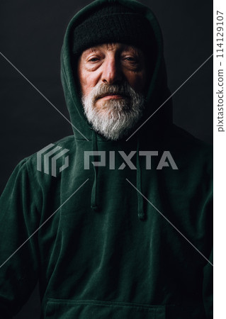 Experienced old man with wrinkles, dressed in warm shabby clothing as a tramp Experienced old man with wrinkles, dressed in warm shabby clothing as a tramp 114129107