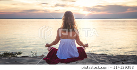 Woman meditating at the sea Woman meditating at the sea 114129398