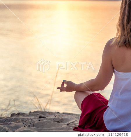 Woman meditating at the sea Woman meditating at the sea 114129418