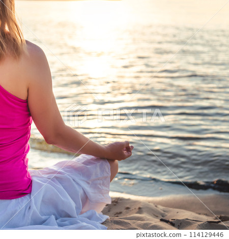 Woman meditating at the sea Woman meditating at the sea 114129446