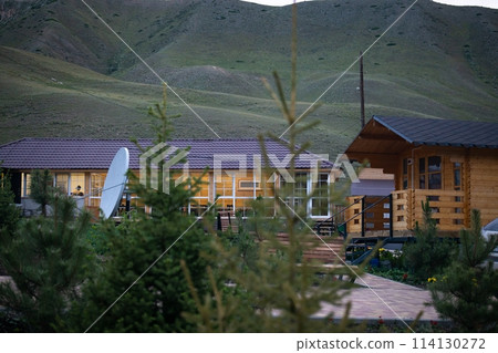 Small wooden cabin in a beautiful mountain landscape with green hills Small wooden cabin in a beautiful mountain landscape with green hills 114130272