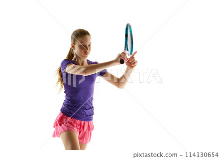 Portrait of focused young girl, tennis player ready to hit ball in motion against white studio background. Model in vibrant uniform. Portrait of focused young girl, tennis player ready to hit ball in motion against white studio background. Model in vibrant uniform. 114130654