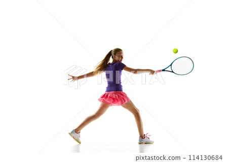 Sportive young girl, tennis athlete in comfortable vibrant uniform playing tennis in motion against white studio background. 114130684