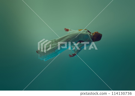 Young woman in dynamic pose, her dress fanning out beautifully during she falling down in water environment. 114130736