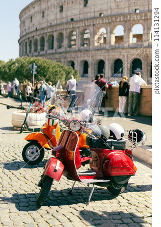 Two Retro scooters stay near the Roman Coliseum. One of the most popular travel place in world, postcard 114131294