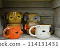 original design of mugs made in a pottery workshop 114131431