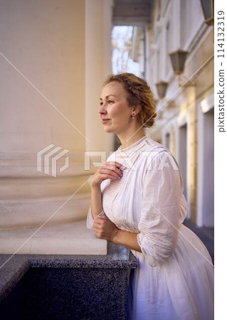 elegant middle age woman in white vintage dress near theater with antique colonnades elegant middle age woman in white vintage dress near theater with antique colonnades 114132319
