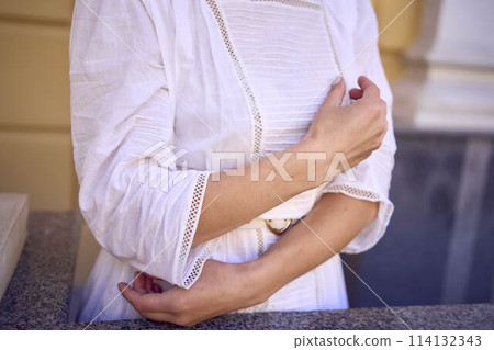 elegant middle age woman in white vintage dress near theater with antique colonnades elegant middle age woman in white vintage dress near theater with antique colonnades 114132343