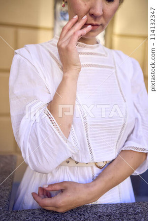 elegant middle age woman in white vintage dress near theater with antique colonnades elegant middle age woman in white vintage dress near theater with antique colonnades 114132347