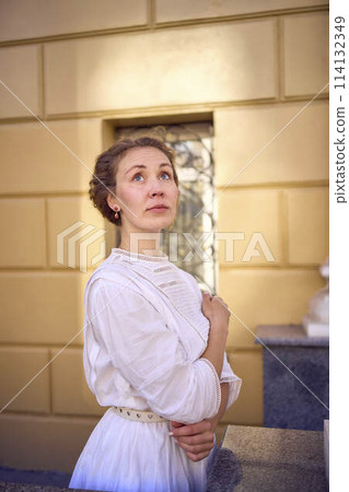 elegant middle age woman in white vintage dress near theater with antique colonnades elegant middle age woman in white vintage dress near theater with antique colonnades 114132349