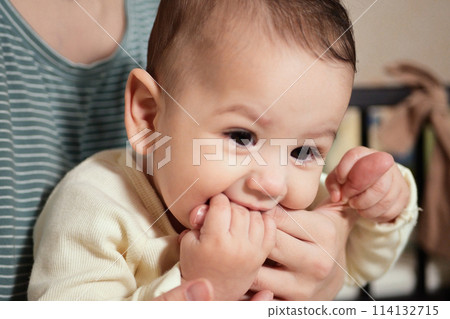 Young mother, kissing her baby boy at home. Family concept. Closeup portrait of loving mother young woman kissing little kid, home interior Young mother, kissing her baby boy at home. Family concept. Closeup portrait of loving mother young woman kissing little kid, home interior 114132715