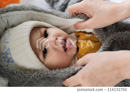 A mother dressing her little baby boy boy at home. childhood parenthood and growing up family concept real people A mother dressing her little baby boy boy at home. childhood parenthood and growing up family concept real people 114132792