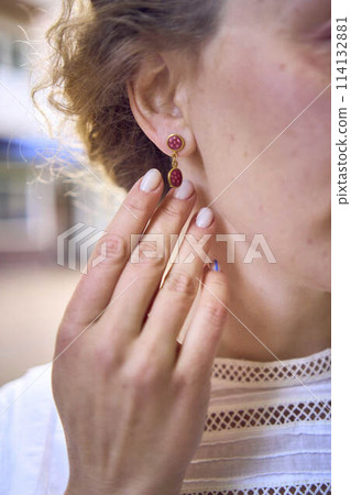 chic middle aged woman in a white vintage dress, details of the outfit chic middle aged woman in a white vintage dress, details of the outfit 114132881